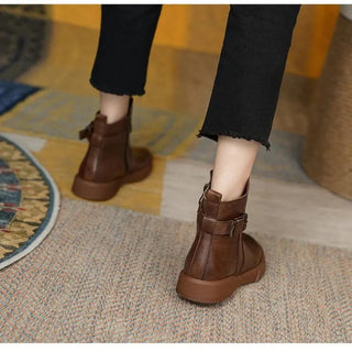 A pair of women's retro-style black boots made from soft leather, featuring a nostalgic design with a comfortable fit and decorative stitching, perfect for both casual and 2