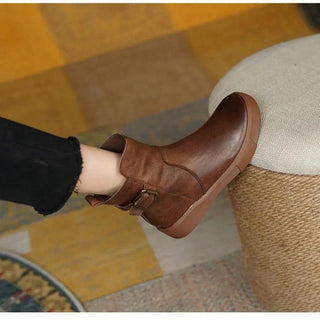 A pair of women's retro-style black boots made from durable leather, featuring a nostalgic design and comfortable fit, perfect for adding a vintage touch to any outfit 3