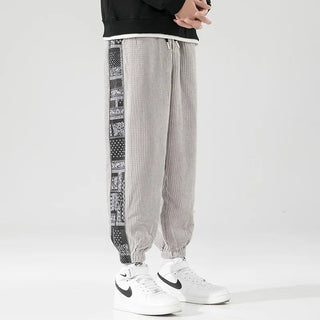 Stylish men's corduroy pants featuring a relaxed fit and trendy side print, crafted from soft cotton material, making them perfect for modern and versatile casual 2