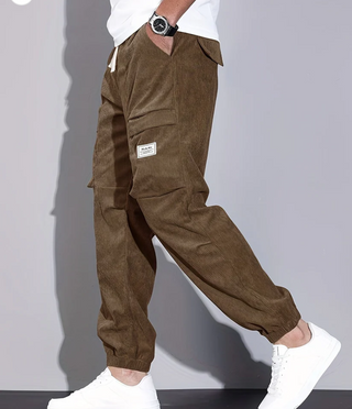 A pair of men's classic design trousers made from durable fabric, featuring practical pockets and a versatile style suitable for both casual and formal occasions. 0