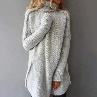 A women's oversized turtleneck sweater made from soft, warm material, featuring a cozy, stylish design perfect for chilly days. 0