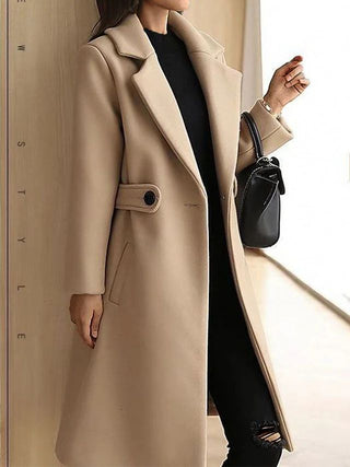 A long black women's coat, elegantly designed for winter, made from high-quality material. Its timeless style features a tailored fit, perfect for both casual and 1