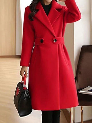 A long, elegant black women's coat made from high-quality material, featuring a timeless design perfect for winter wear. 6