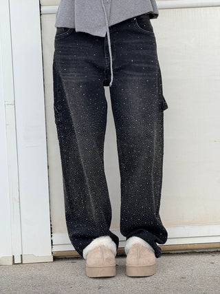 A pair of women's baggy jeans made from soft denim, featuring an artistic design that adds a unique touch. These comfortable jeans offer a relaxed fit, 9