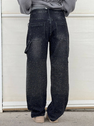 A pair of women's baggy jeans made from soft, durable denim, featuring an artistic design. These comfortable jeans offer a relaxed fit, perfect for casual 2