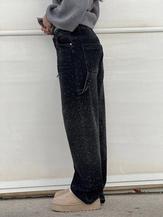 A pair of women's baggy jeans made from soft, durable denim, featuring an artistic design and comfortable fit, perfect for casual outings or creative expression. 5