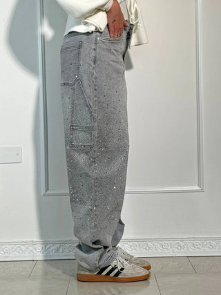 A pair of women's baggy jeans made from soft, comfortable denim, featuring an artistic design. These stylish jeans offer a relaxed fit, perfect for casual 7